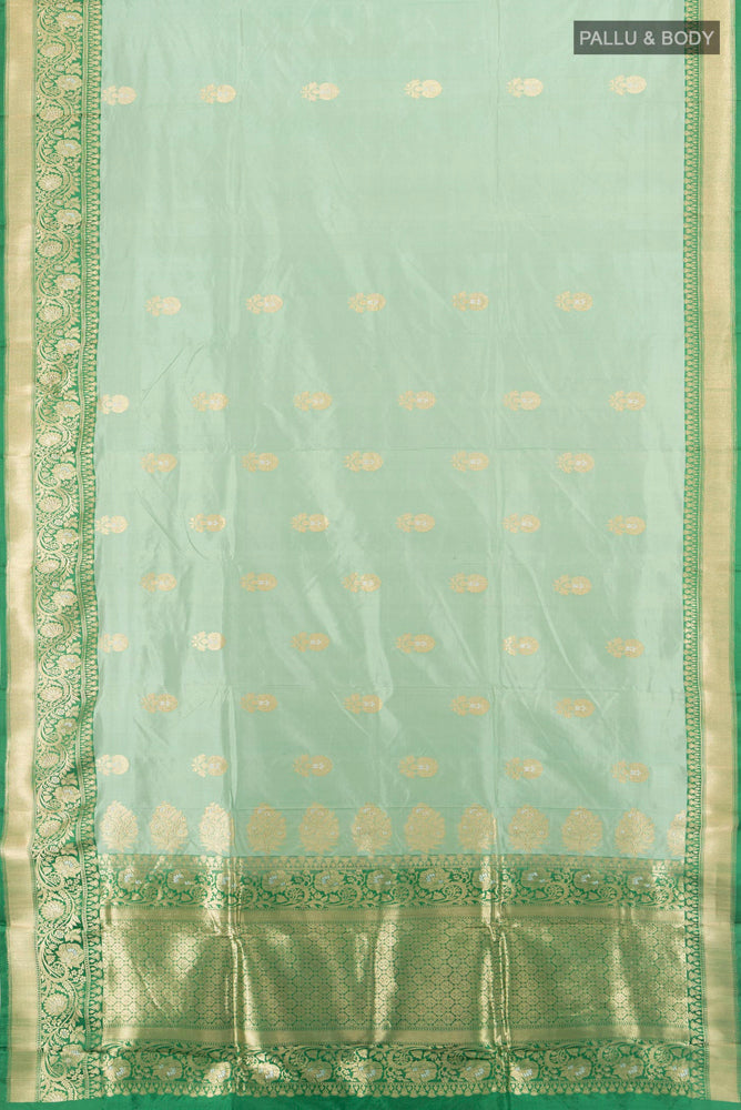 Flat view of Light Green Banarasi Katan Silk Saree with Zari Butta on the body and Silk Border. 