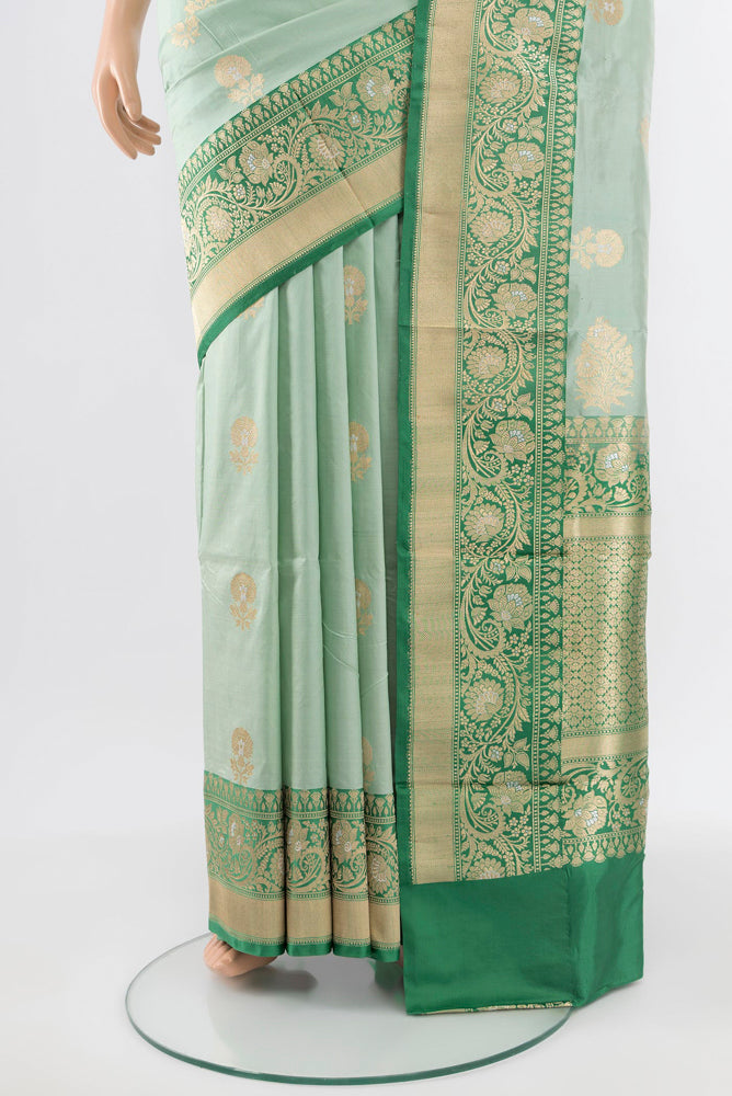 Pleats and pallu of Light Green Banarasi Katan Silk Saree with Zari Butta on the body and Silk Border. 