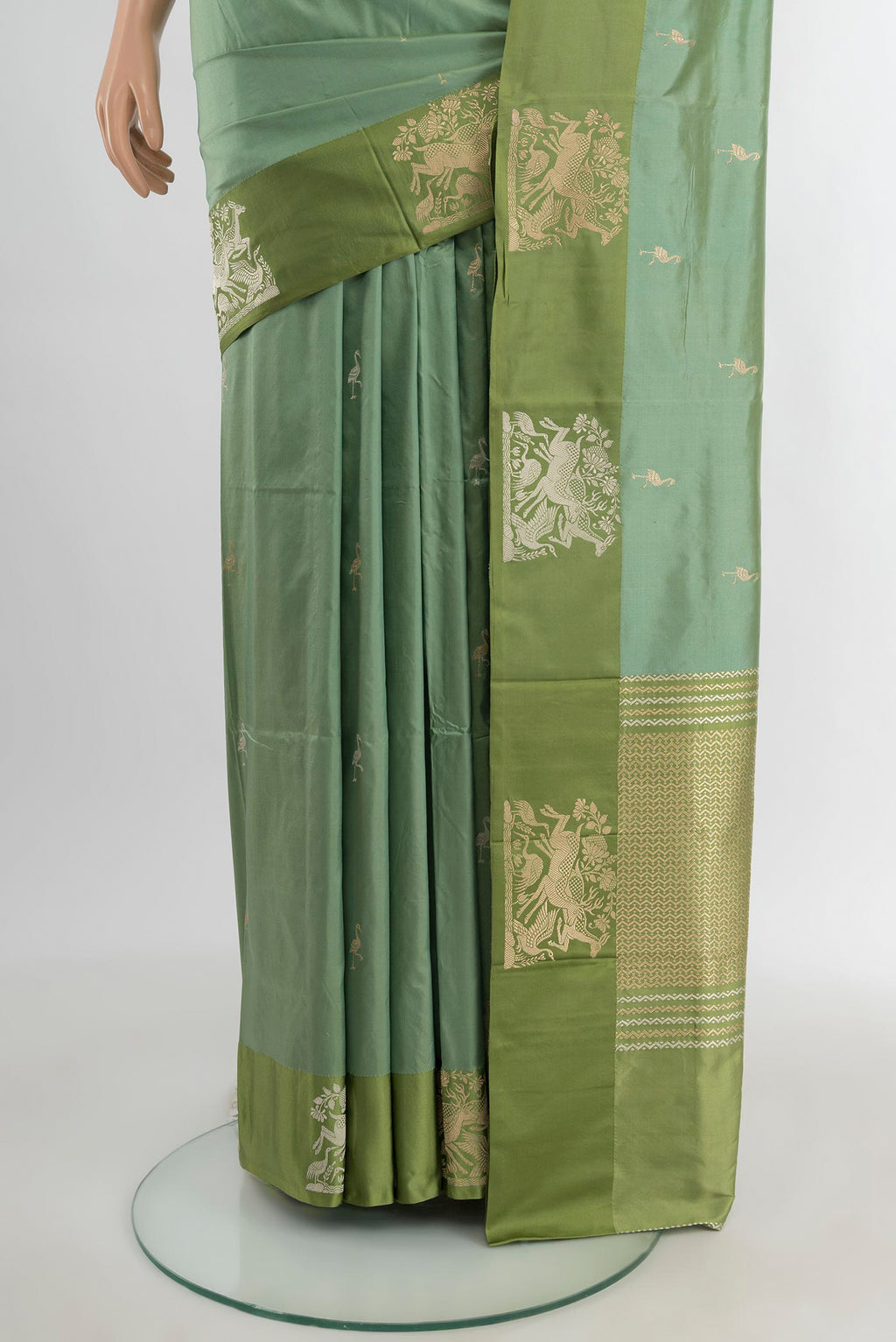 Pleats and pallu of Sage Green Banarasi Katan Silk Saree with Zari Butta on the body and Temple Thread Border. 