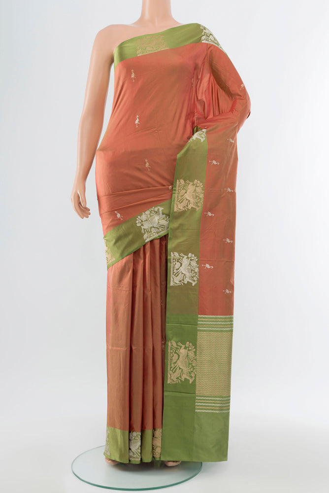 Peach Banarasi Katan Silk Saree with Zari Butta on the body and Silk Border.  displayed on a mannequin