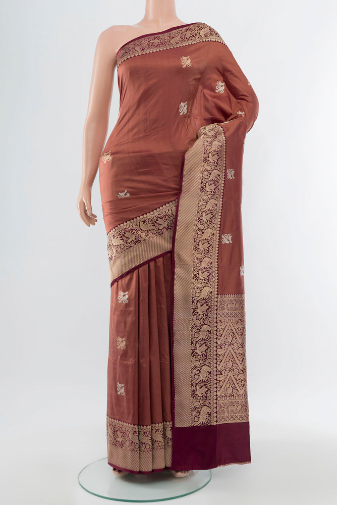 Bronze Banarasi Katan Silk Saree with Zari Butta on the body and Silk Border.  displayed on a mannequin