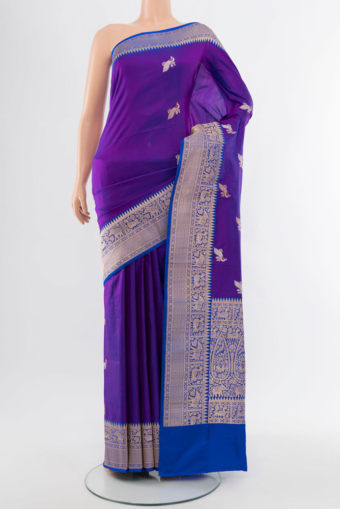 Violet Banarasi Katan Silk Saree with Zari Butta on the body and Silk Border.  displayed on a mannequin