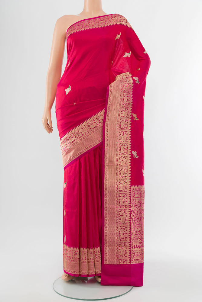 Dark Pink Banarasi Katan Silk Saree with Zari Butta on the body and Silk Border.  displayed on a mannequin