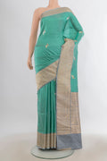 Pure Silk Green Banarasi Katan Saree with Zari Butta on the body and Zari Border.  displayed on a mannequin