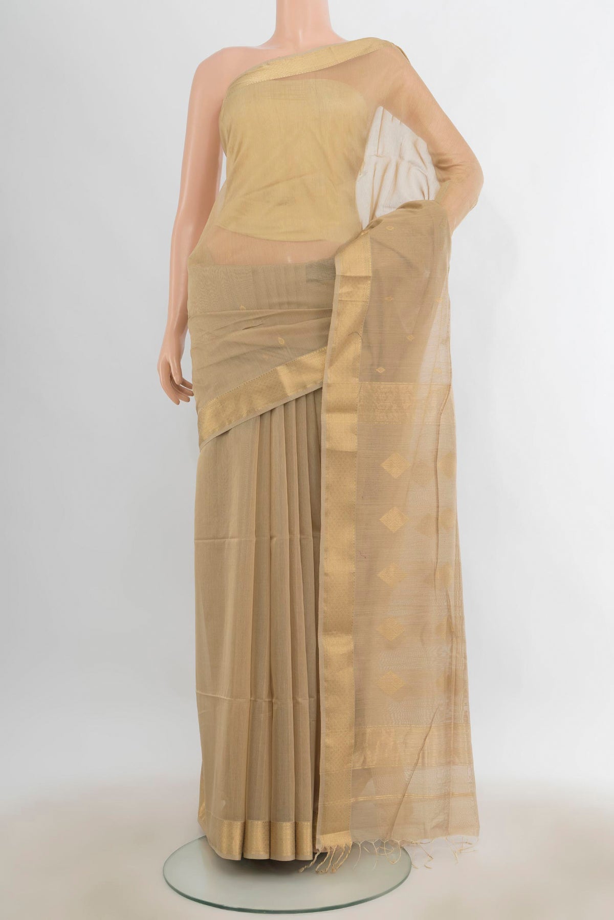 Beige Maheshwari Cotton Saree with Zari Butta on the body and Zari Border.  displayed on a mannequin