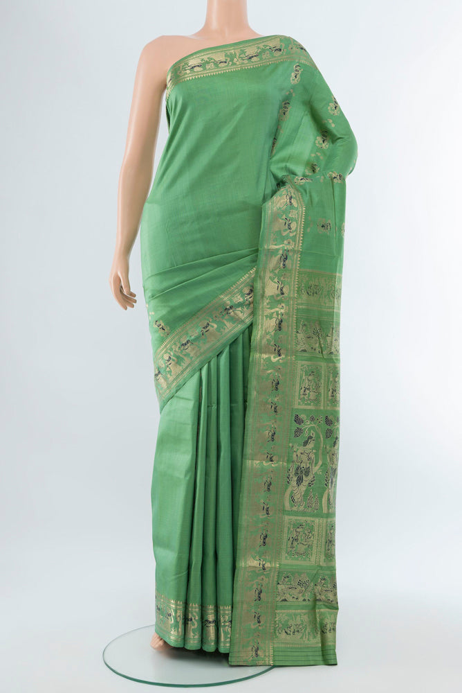 Light Green Baluchari Silk Saree with Zari Butta on the body and Silk Border.  displayed on a mannequin