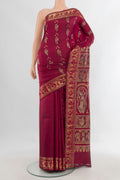Pure Silk Maroon Baluchari Saree with Zari Butta on the body and Zari Border.  displayed on a mannequin