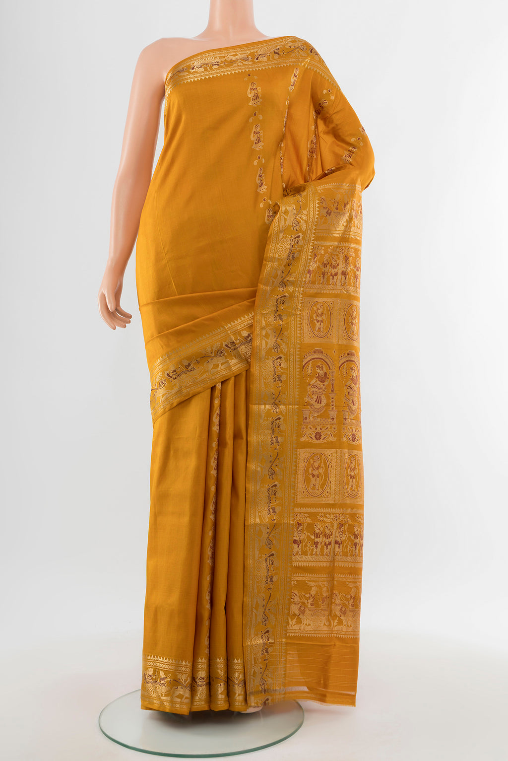 Mustard Baluchari Silk Saree with Zari Butta on the body and Silk Border.  displayed on a mannequin