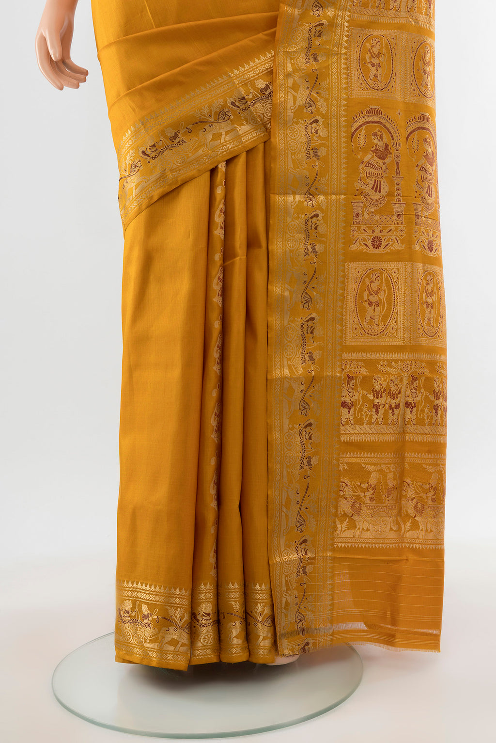 Pleats and pallu of Mustard Baluchari Silk Saree with Zari Butta on the body and Silk Border. 