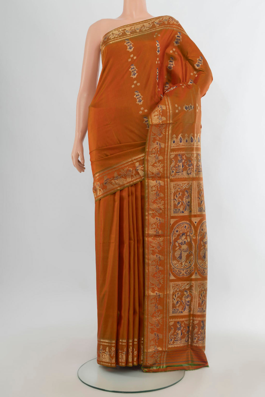 Pure Silk Rust Baluchari Saree with Zari And Thread Butta on the body and Zari Border.  displayed on a mannequin