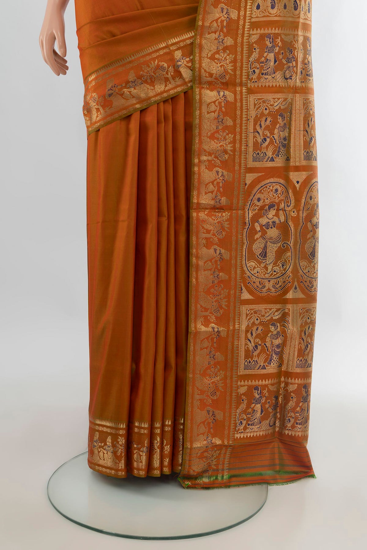 Pleats and pallu of Pure Silk Rust Baluchari Saree with Zari And Thread Butta on the body and Zari Border. 