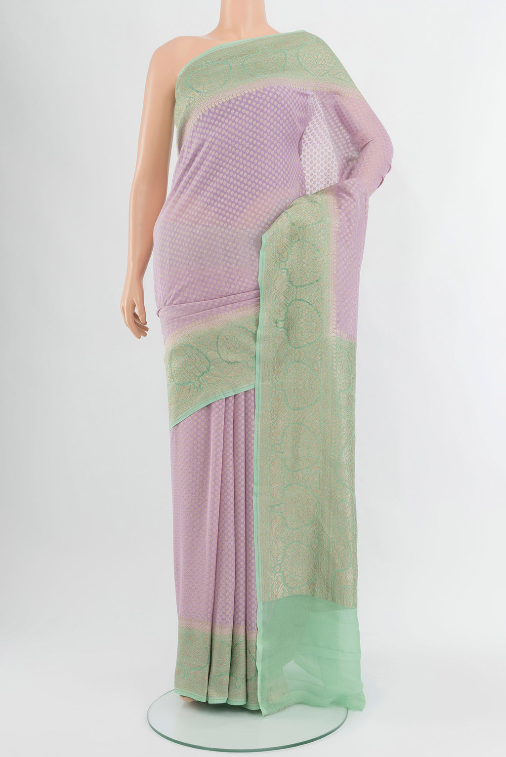 Lavender Banarasi Georgette Saree with Zari Butta on the body and Zari Border.  displayed on a mannequin
