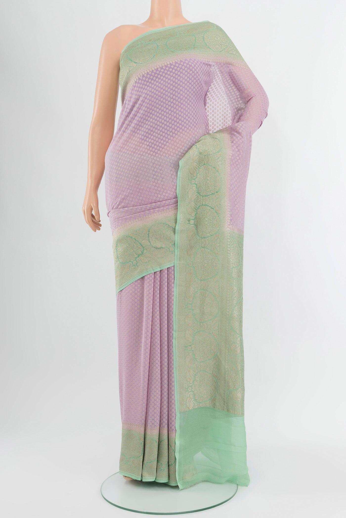 Lavender Banarasi Georgette Saree with Zari Butta on the body and Zari Border.  displayed on a mannequin