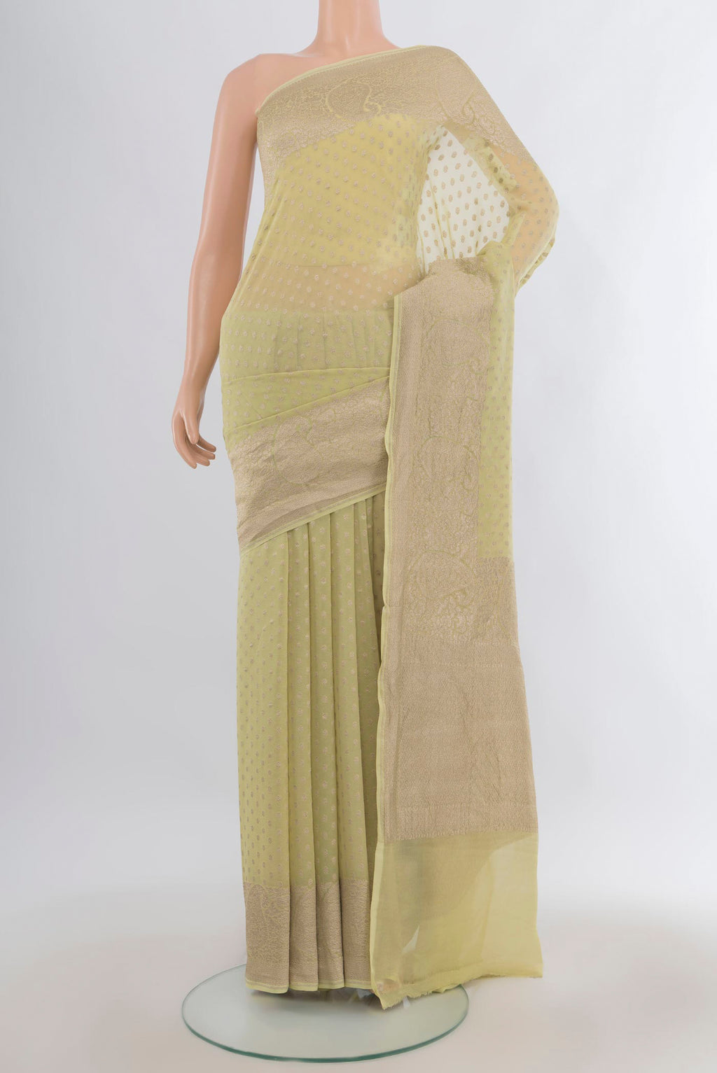 Pista Green Banarasi Georgette Saree with Zari Butta on the body and Zari Border.  displayed on a mannequin