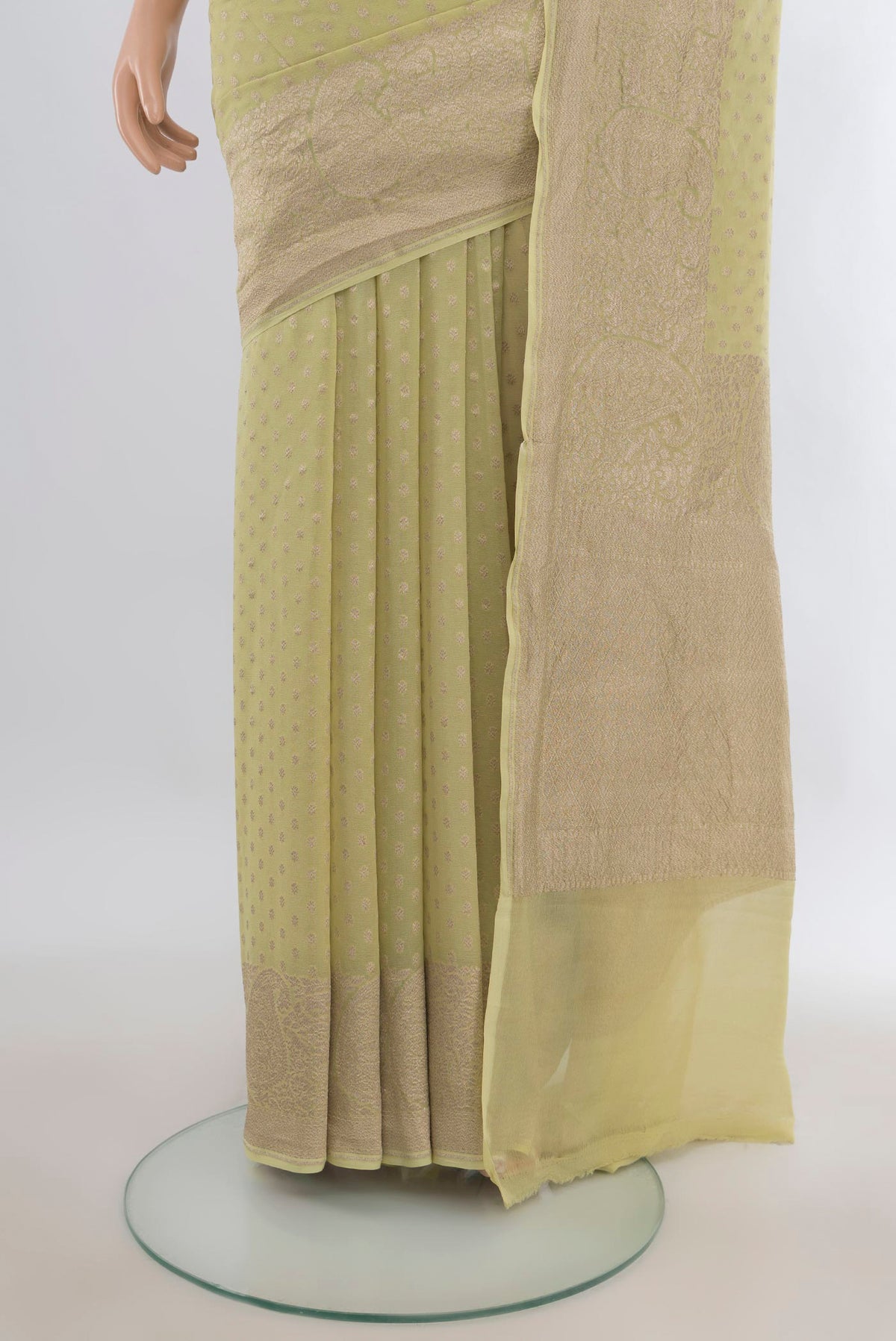 Pleats and pallu of Pista Green Banarasi Georgette Saree with Zari Butta on the body and Zari Border. 