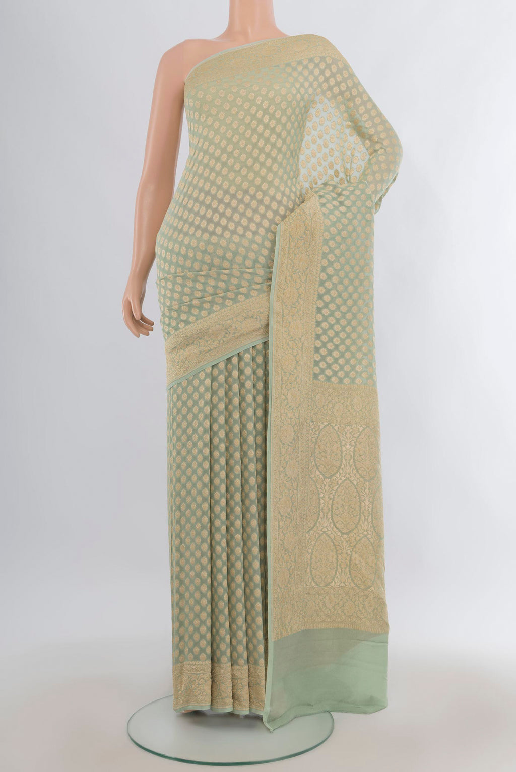 Pista Green Banarasi Georgette Saree with Zari Butta on the body and Zari Border.  displayed on a mannequin
