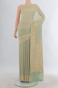 Pista Green Banarasi Georgette Saree with Zari Butta on the body and Zari Border.  displayed on a mannequin