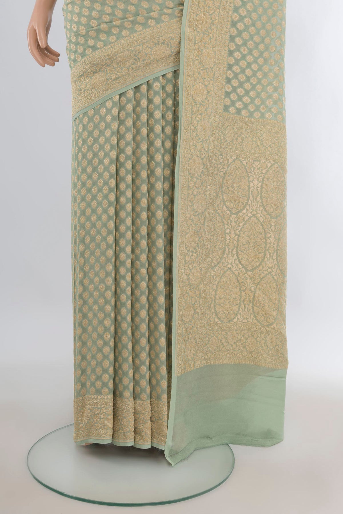 Pleats and pallu of Pista Green Banarasi Georgette Saree with Zari Butta on the body and Zari Border. 