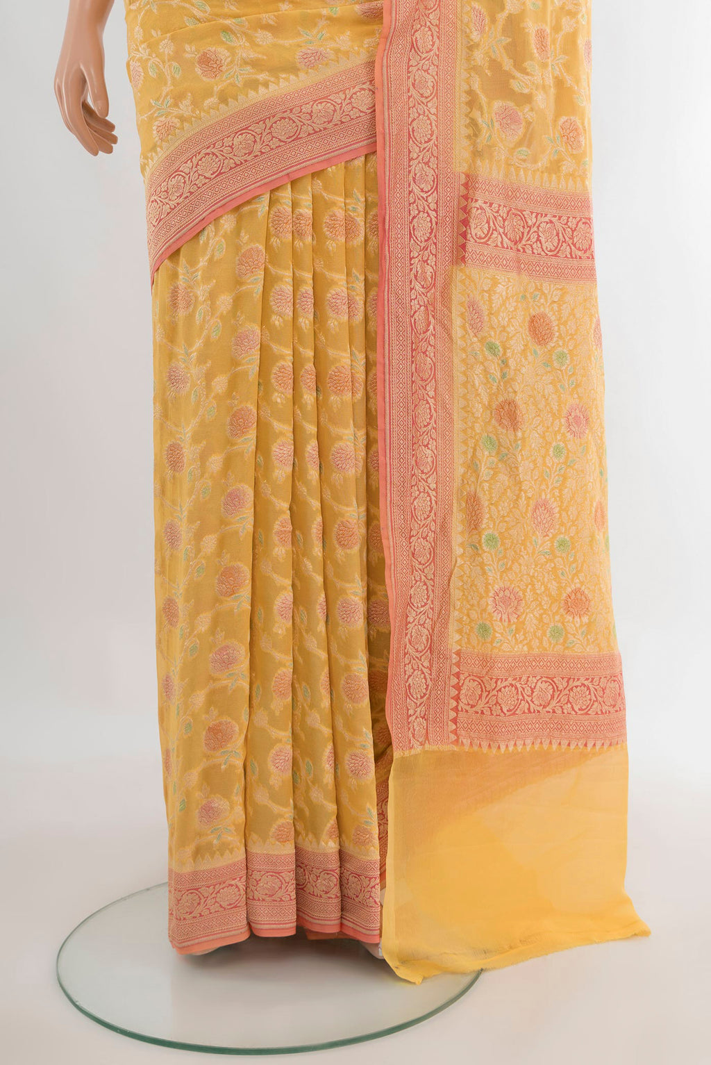 Pleats and pallu of Yellow Banarasi Georgette Saree with Zari Brocade on the body and Zari Border. 