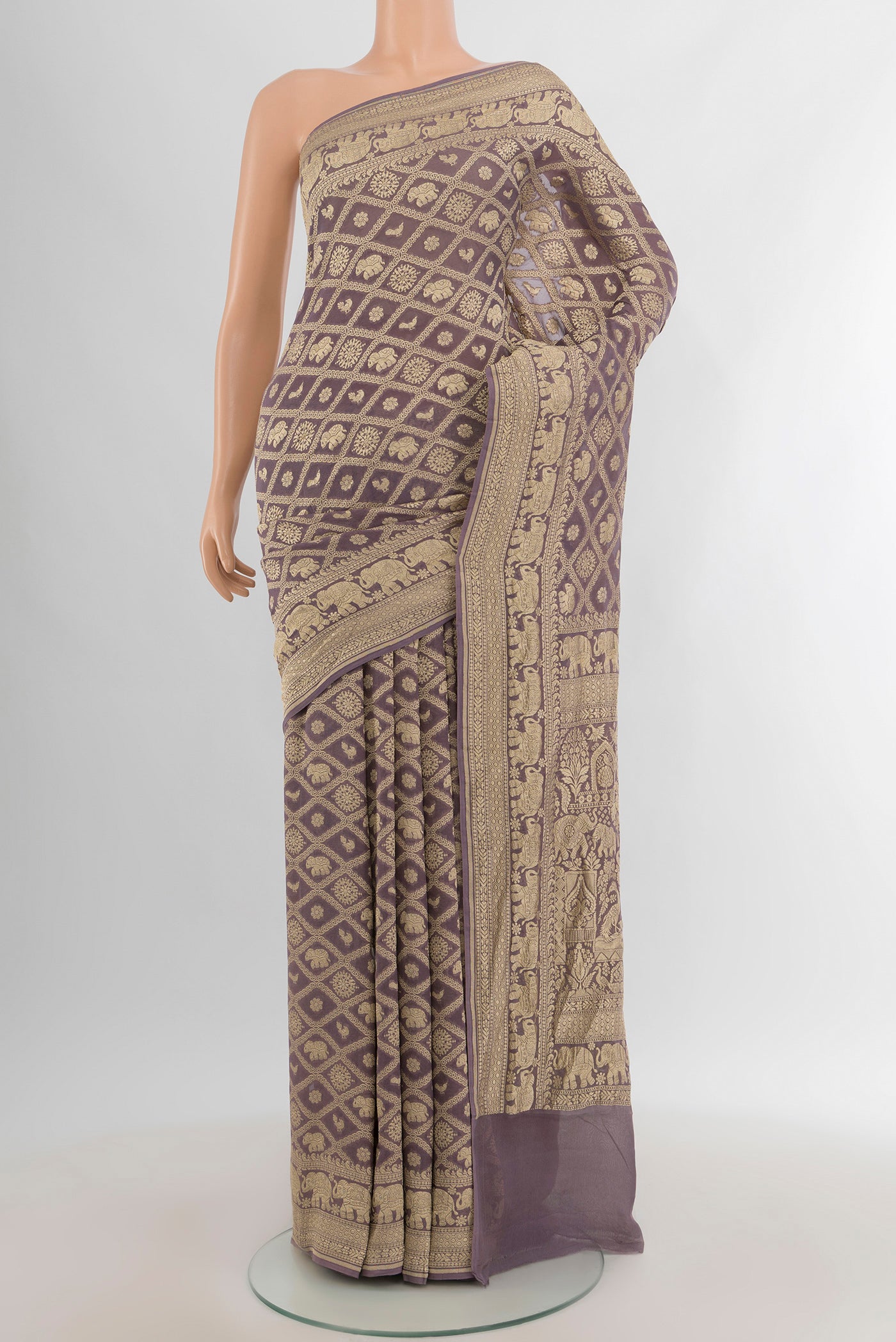 Lavender Banarasi Georgette Saree with Zari Brocade on the body and Zari Border.  displayed on a mannequin