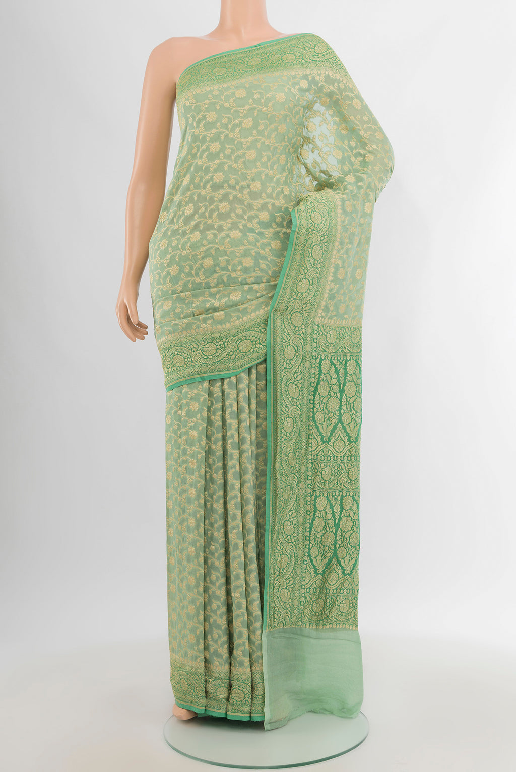 Light Green Banarasi Georgette Saree with Zari Brocade on the body and Zari Border.  displayed on a mannequin