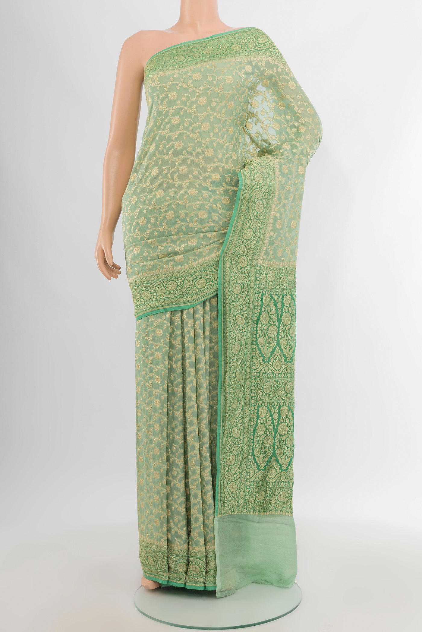 Light Green Banarasi Georgette Saree with Zari Brocade on the body and Zari Border.  displayed on a mannequin