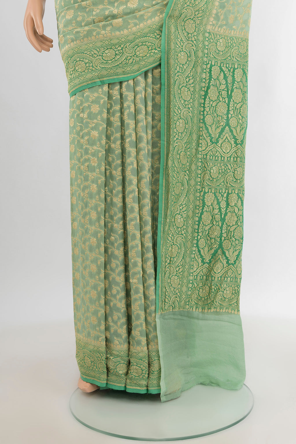 Pleats and pallu of Light Green Banarasi Georgette Saree with Zari Brocade on the body and Zari Border. 