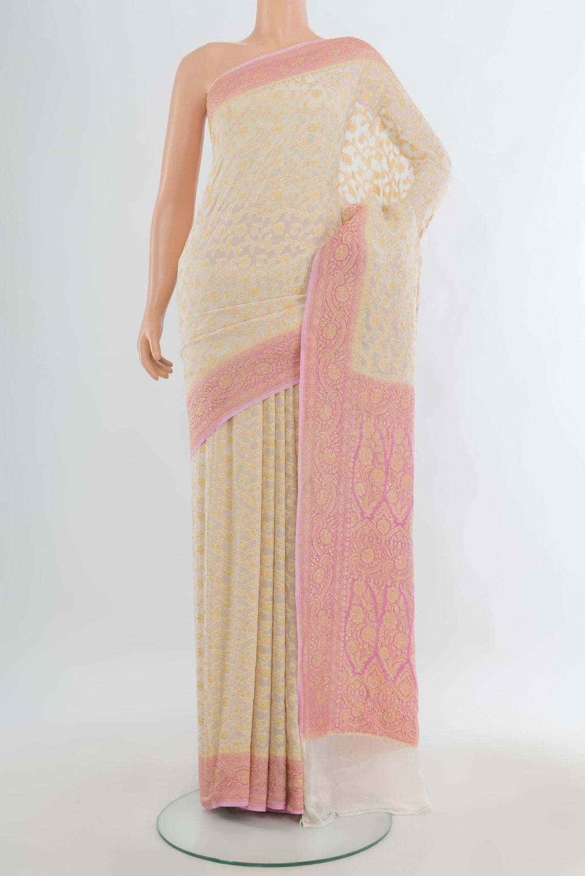 Cream Banarasi Georgette Saree with Zari Brocade on the body and Zari Border.  displayed on a mannequin