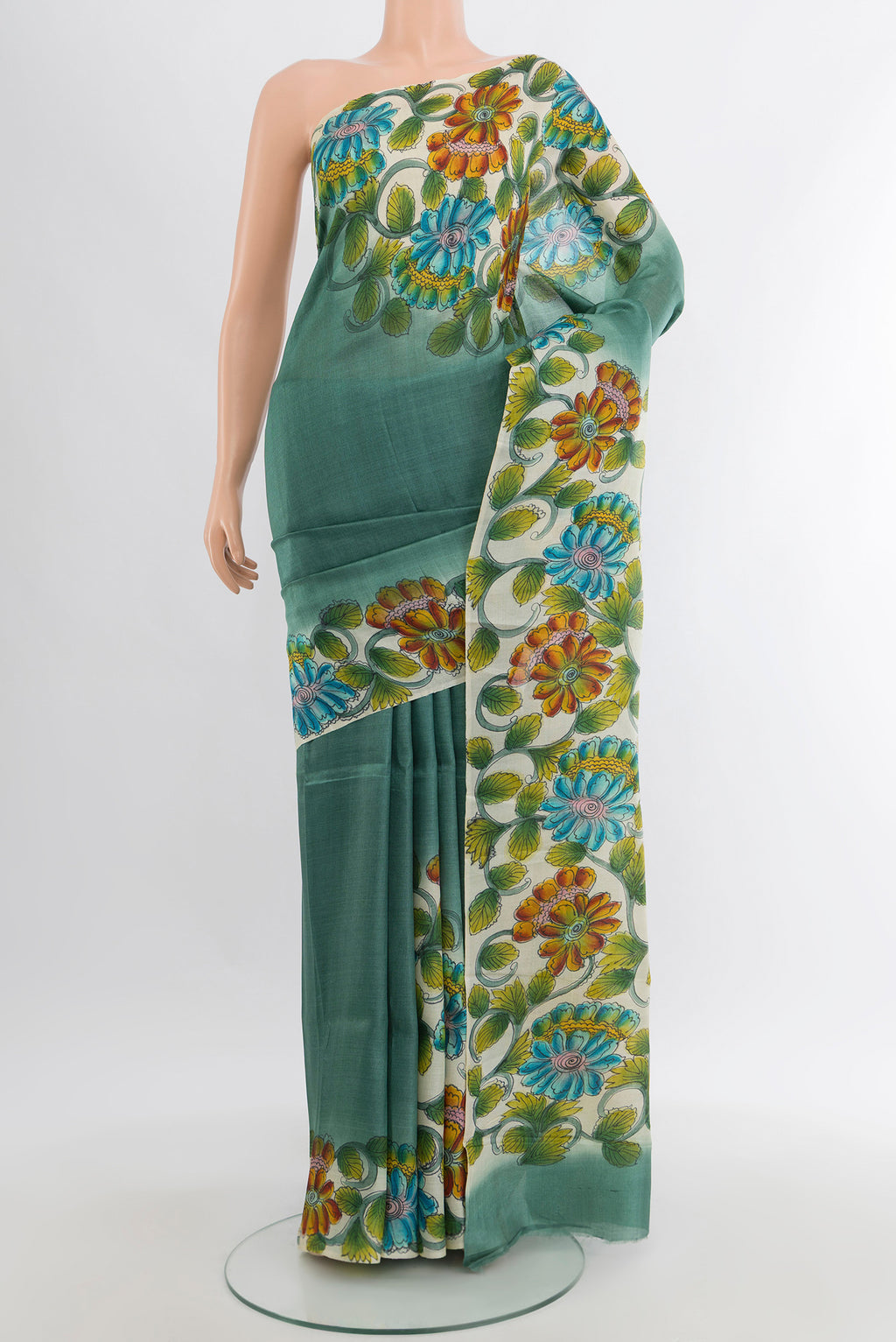 Teal Tussar Silk Saree with Floral Print on the body and Printed Border.  displayed on a mannequin