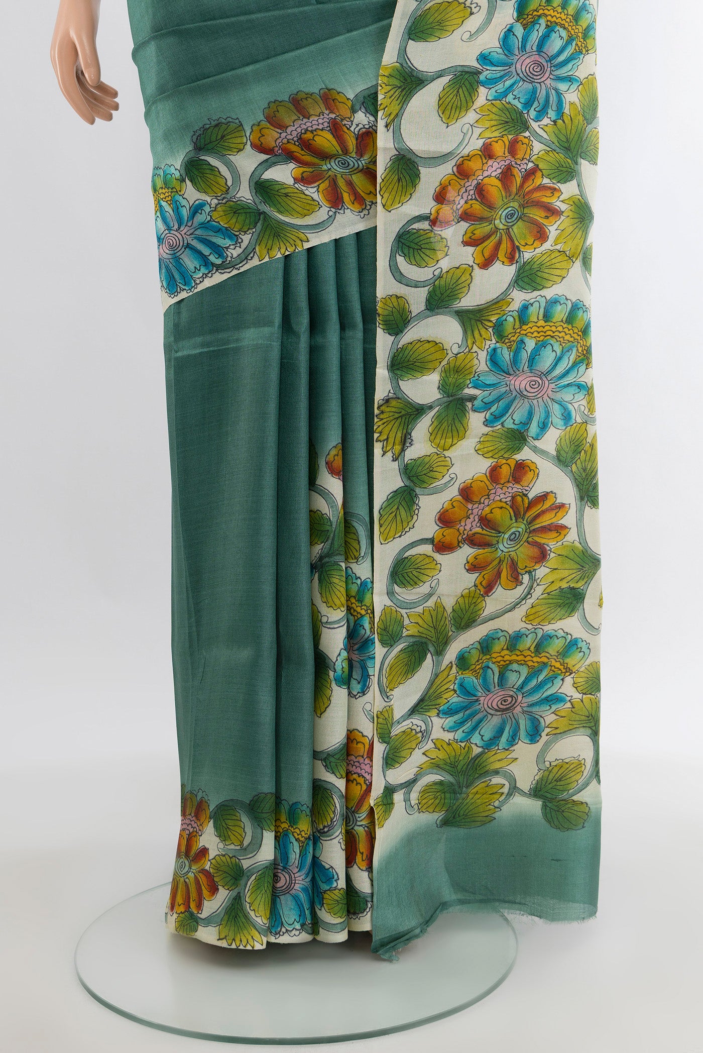 Pleats and pallu of Teal Tussar Silk Saree with Floral Print on the body and Printed Border. 