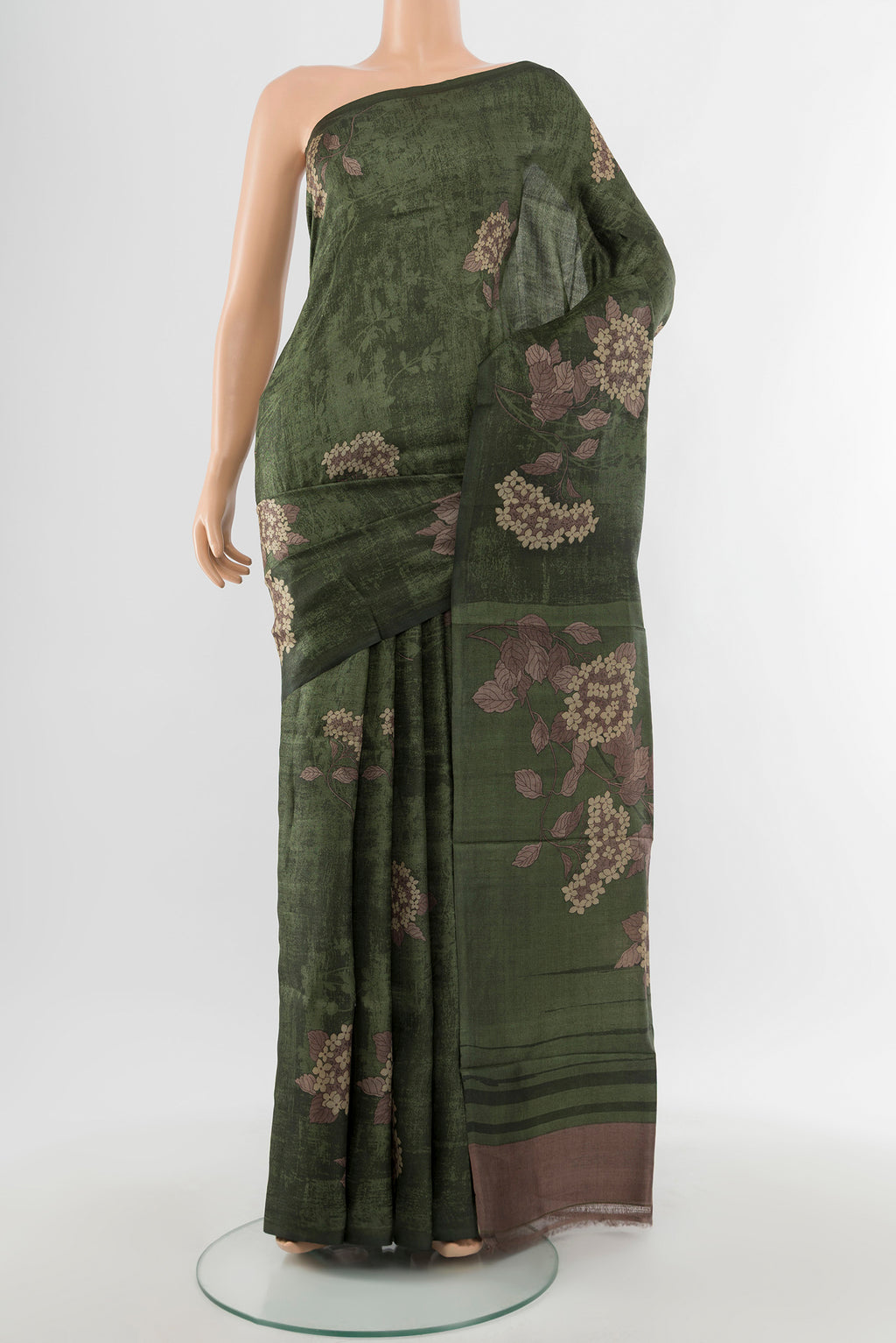Mint Green Tussar Silk Saree with Floral Print on the body and Silk Border.  displayed on a mannequin