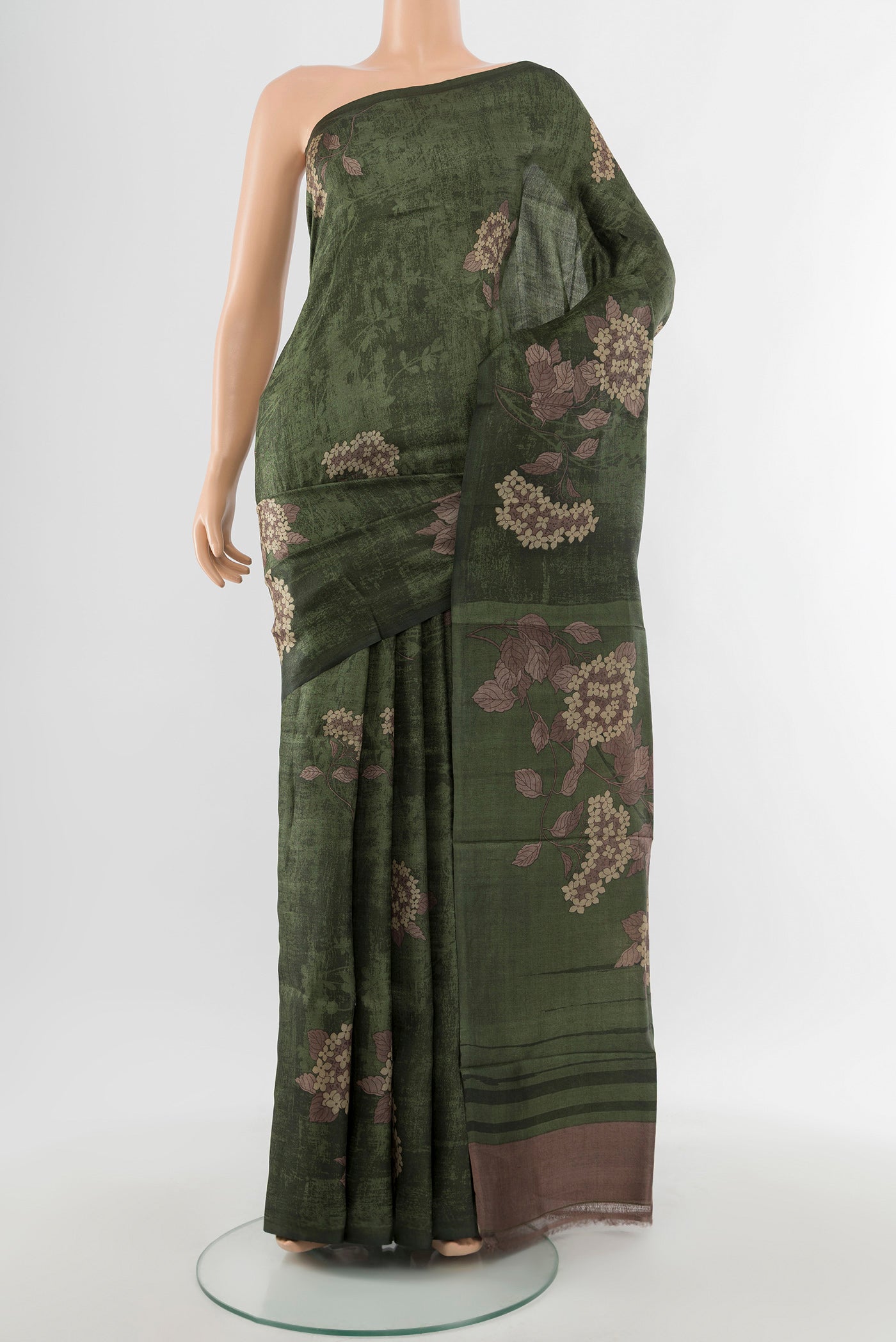 Mint Green Tussar Silk Saree with Floral Print on the body and Silk Border.  displayed on a mannequin