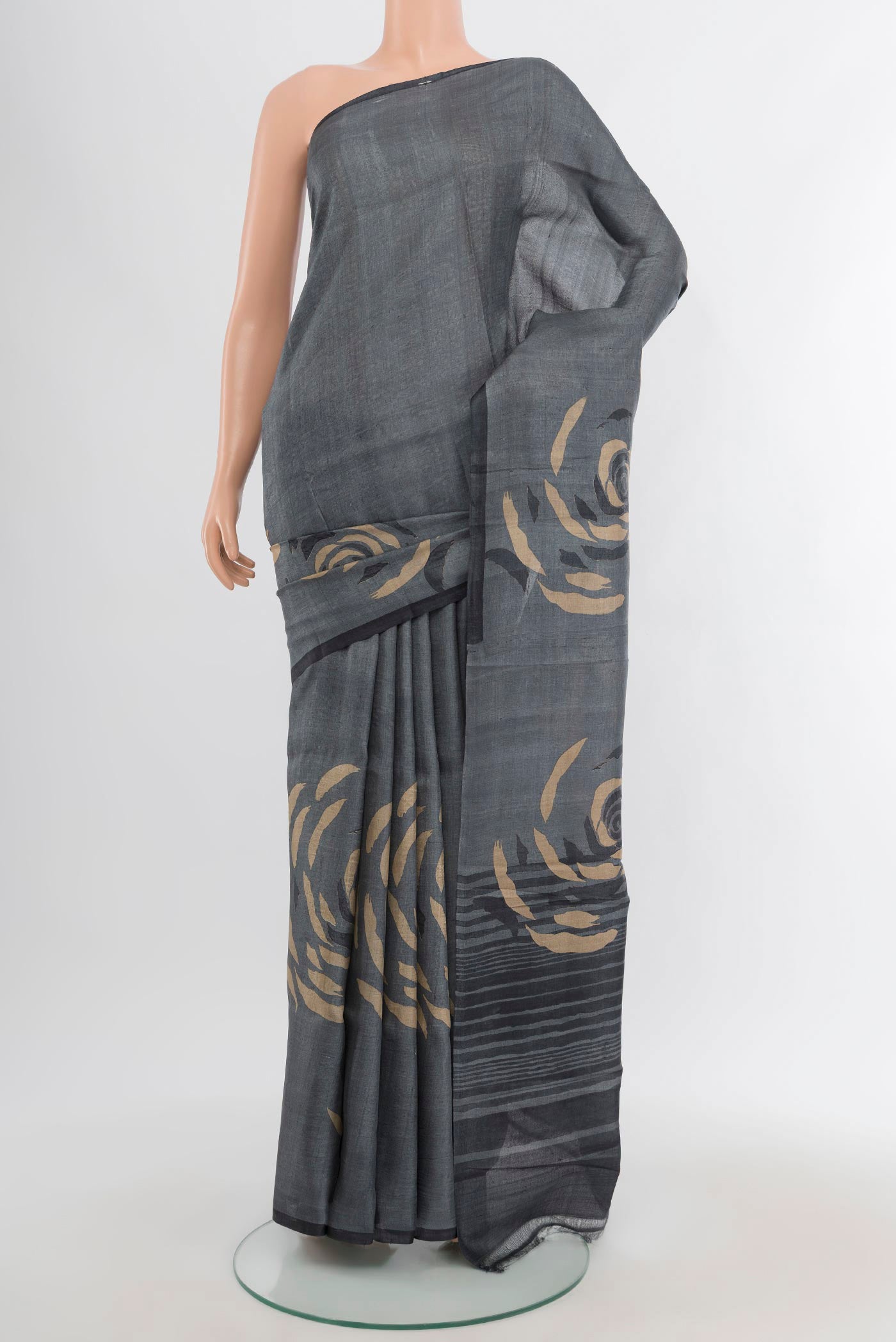 Davys Grey Tussar Silk Saree with Plain Body and Without Border.  displayed on a mannequin