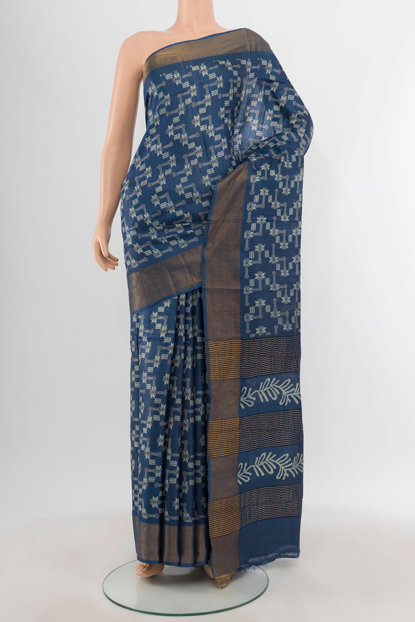 Blue Tussar Silk Saree with Floral Print on the body and Zari Border.  displayed on a mannequin