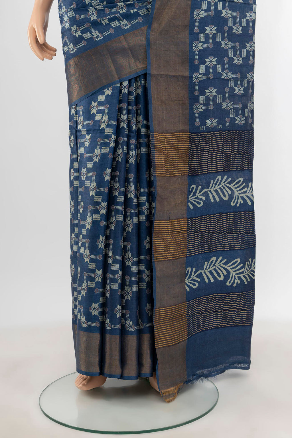 Pleats and pallu of Blue Tussar Silk Saree with Floral Print on the body and Zari Border. 