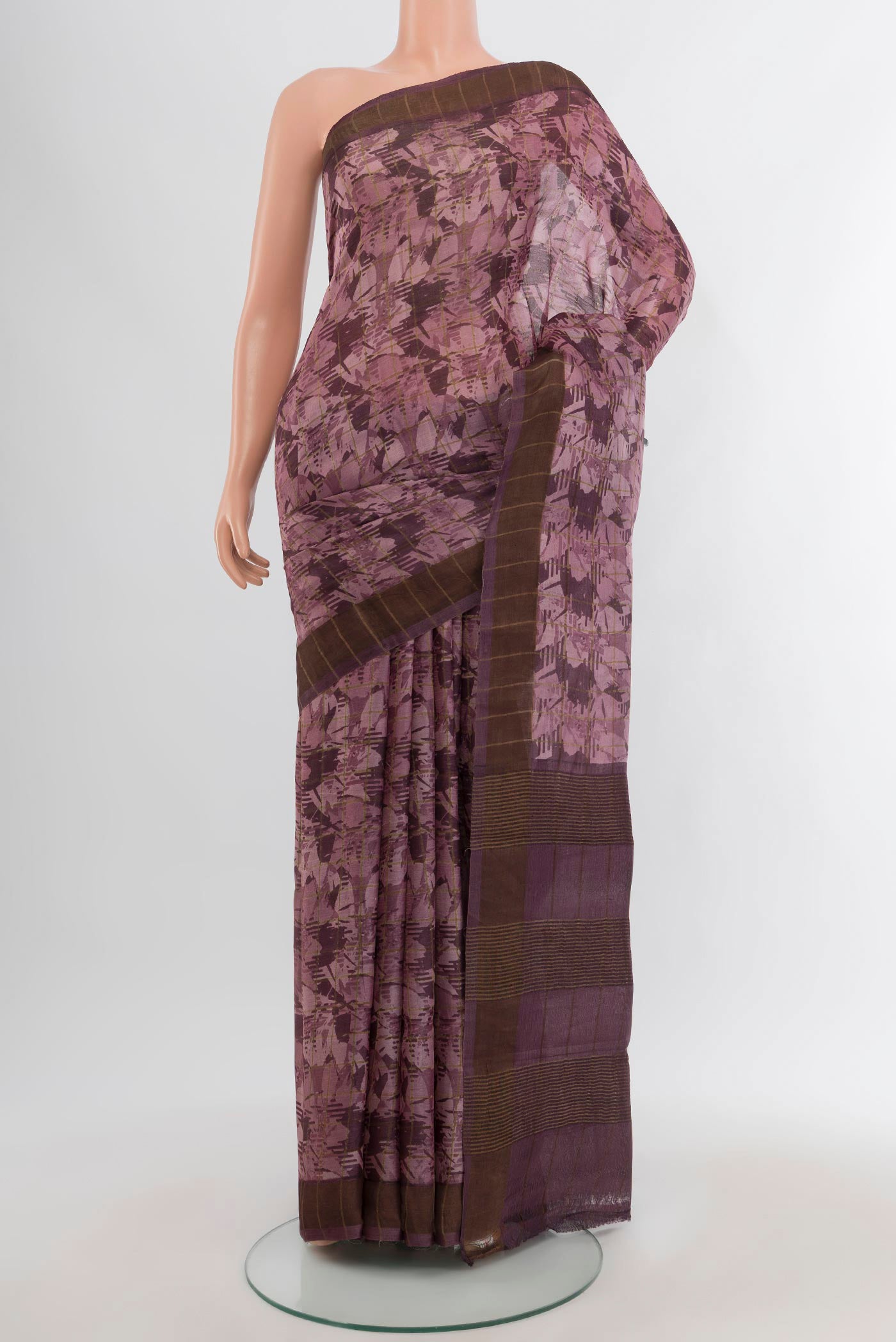 Mauve Tussar Silk Saree with Floral Print on the body and Zari Border.  displayed on a mannequin