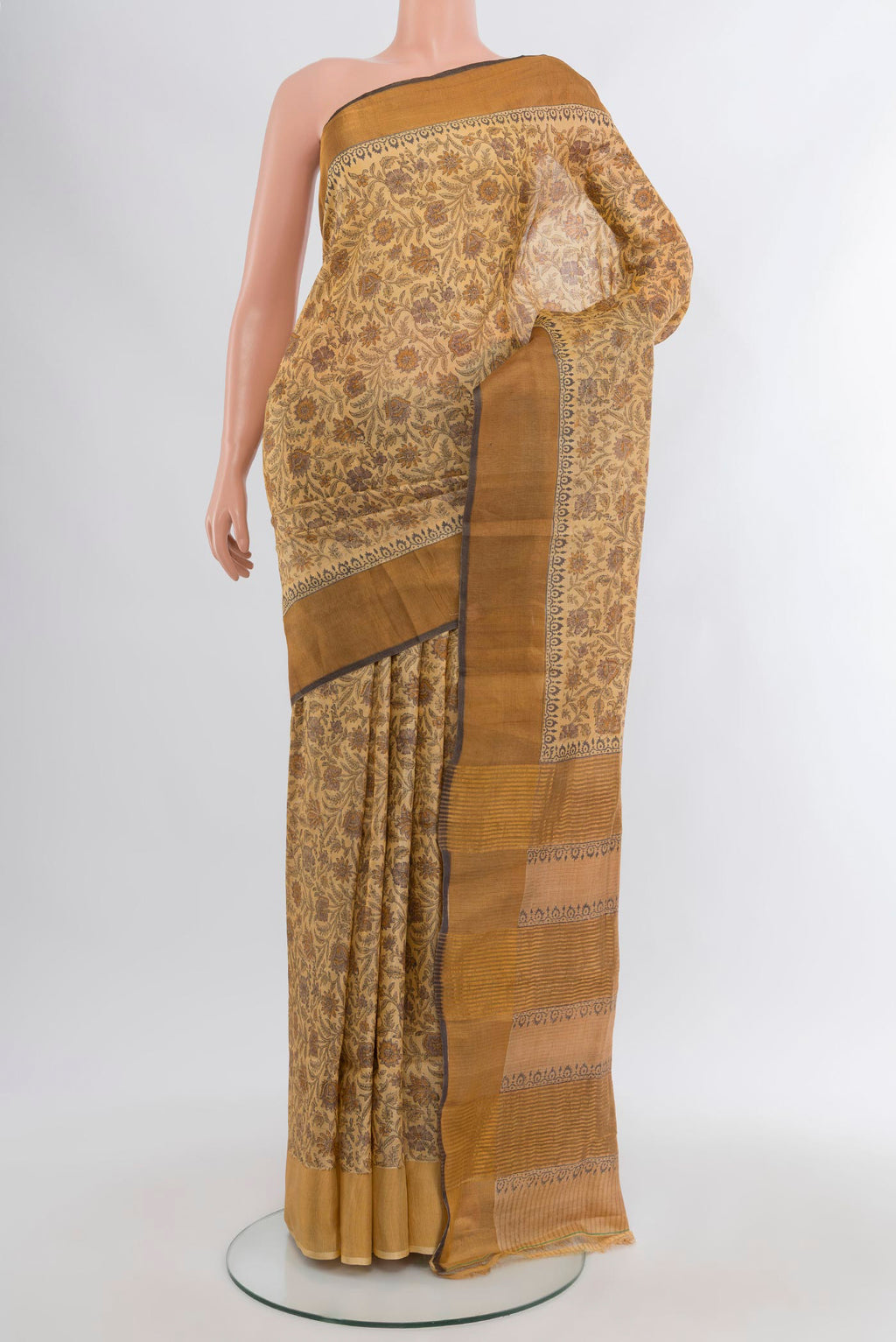 Beige Tussar Silk Saree with Floral Print on the body and Zari Border.  displayed on a mannequin