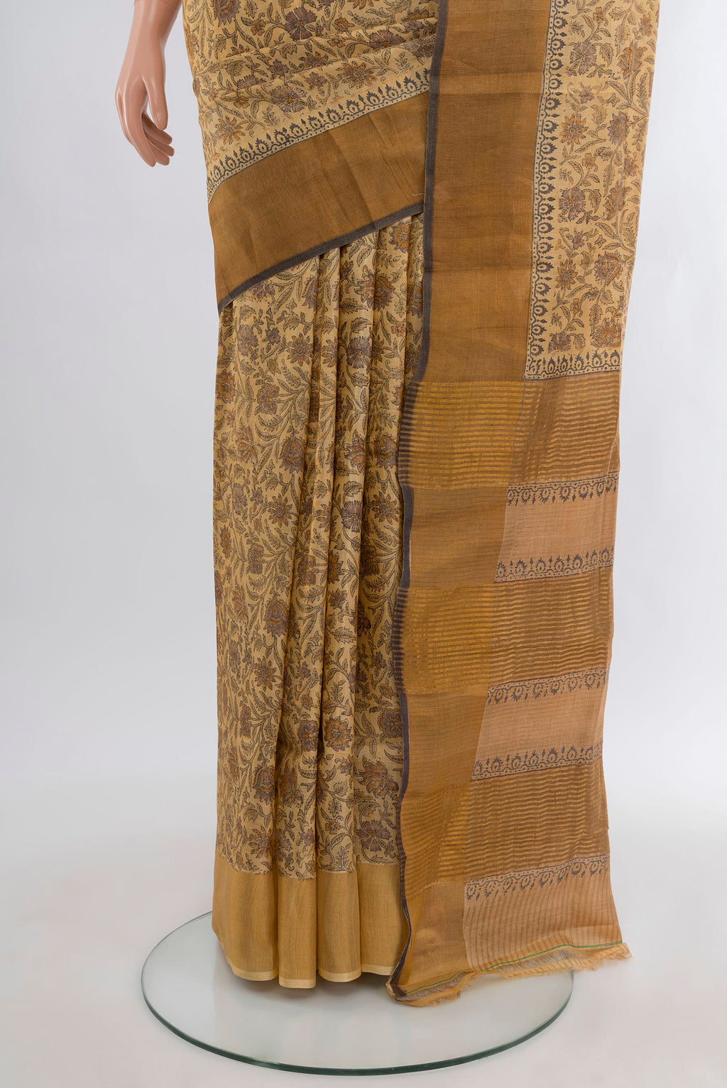 Pleats and pallu of Beige Tussar Silk Saree with Floral Print on the body and Zari Border. 