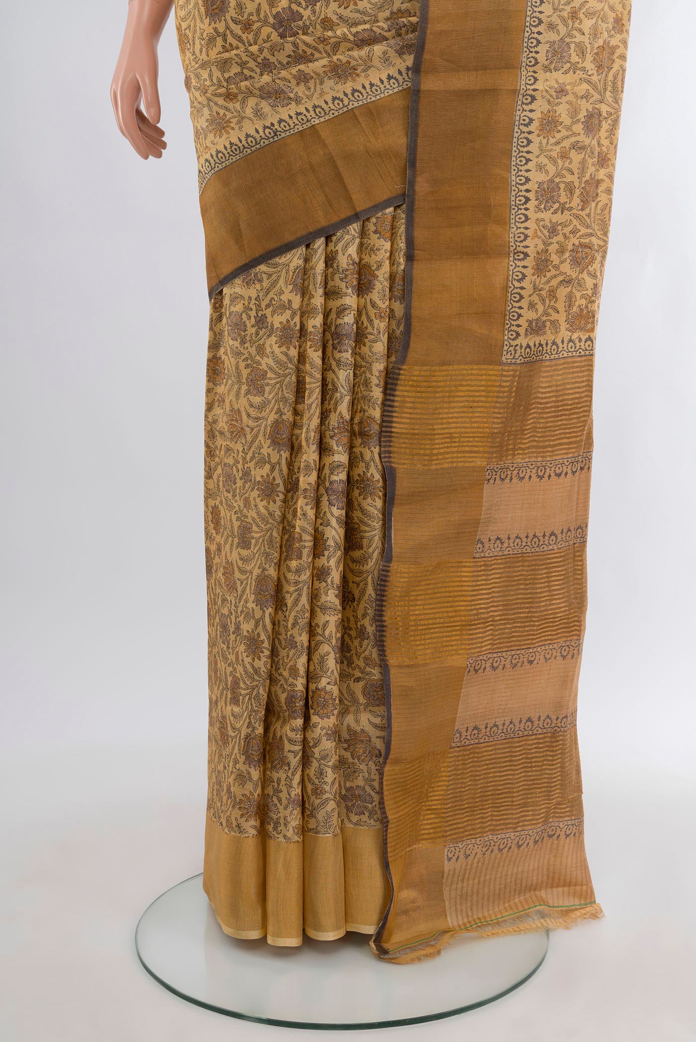 Pleats and pallu of Beige Tussar Silk Saree with Floral Print on the body and Zari Border. 