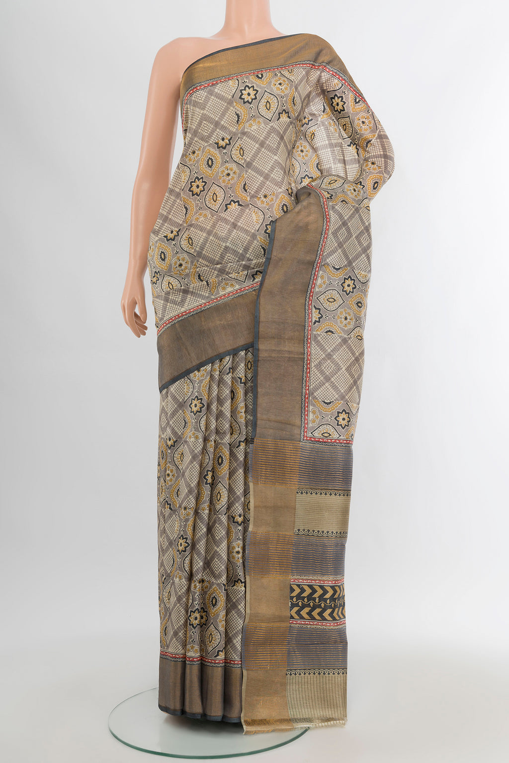 Grey Tussar Silk Saree with Floral Print on the body and Zari Border.  displayed on a mannequin