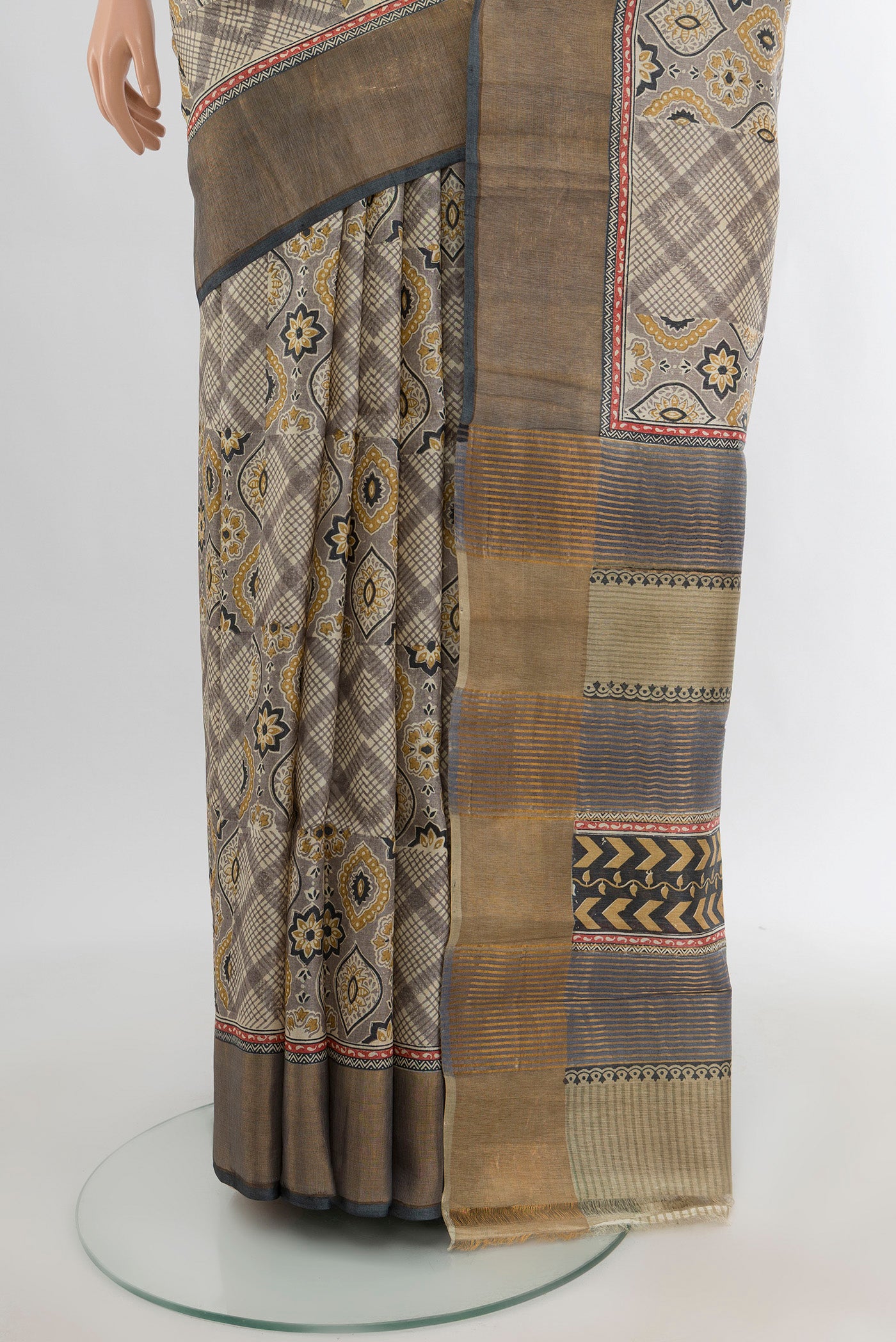 Pleats and pallu of Grey Tussar Silk Saree with Floral Print on the body and Zari Border. 