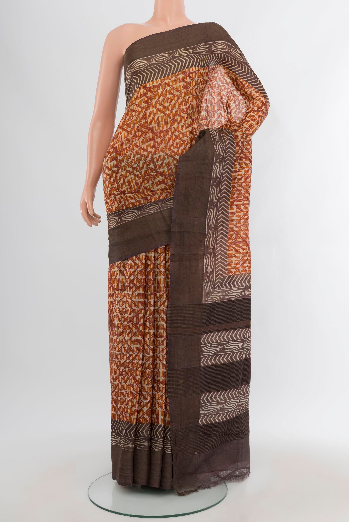 Mustard Tussar Silk Saree with Floral Print on the body and Printed Border.  displayed on a mannequin