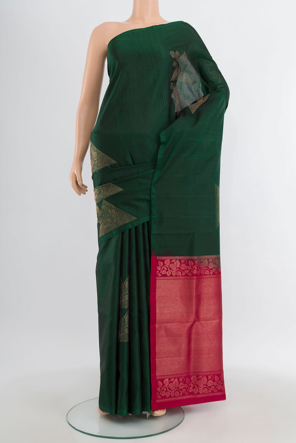 Bottle Green Soft Silk Saree with Zari Butta on the body and Without Border.  displayed on a mannequin