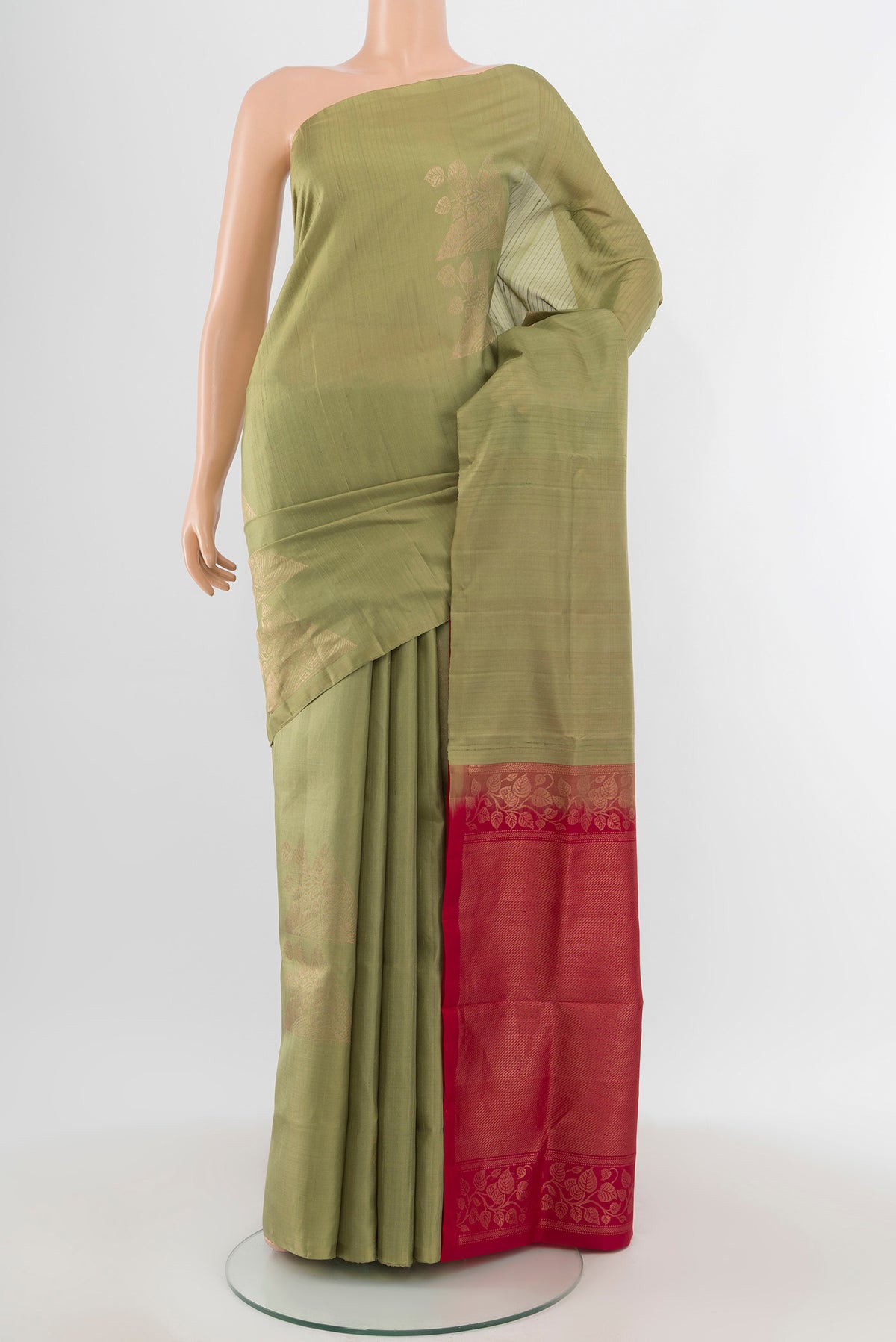 Sage Green Soft Silk Saree with Zari Butta on the body and Without Border.  displayed on a mannequin