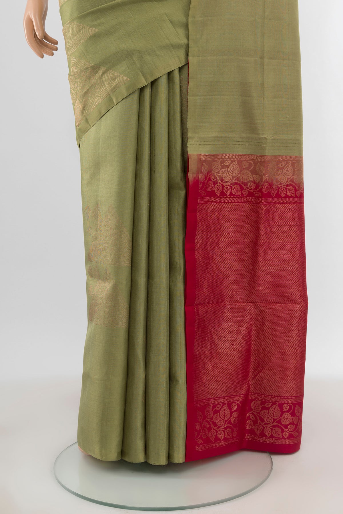 Pleats and pallu of Sage Green Soft Silk Saree with Zari Butta on the body and Without Border. 