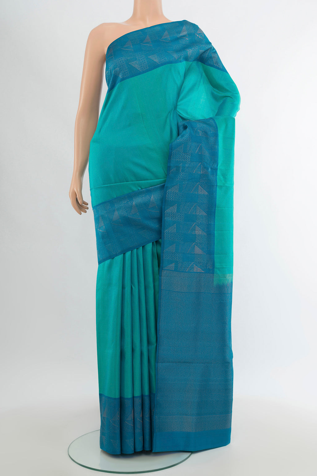 Turquoise Soft Silk Saree with Plain Body and Fancy Border.  displayed on a mannequin