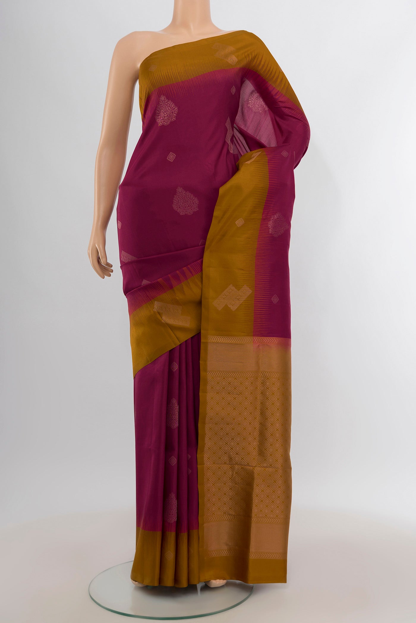 Maroon Soft Silk Saree with Zari Butta on the body and Plain Border.  displayed on a mannequin