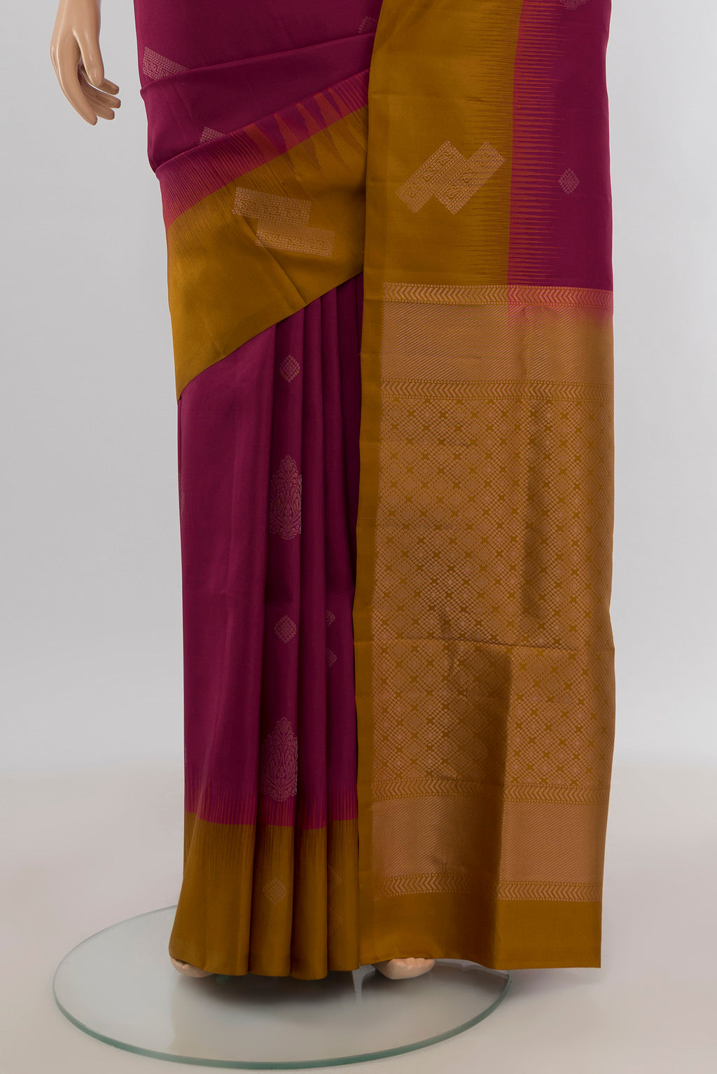 Pleats and pallu of Maroon Soft Silk Saree with Zari Butta on the body and Plain Border. 