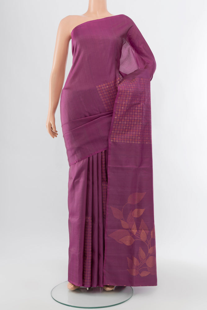 Bronze Soft Silk Saree with Zari Butta on the body and Silk Border.  displayed on a mannequin