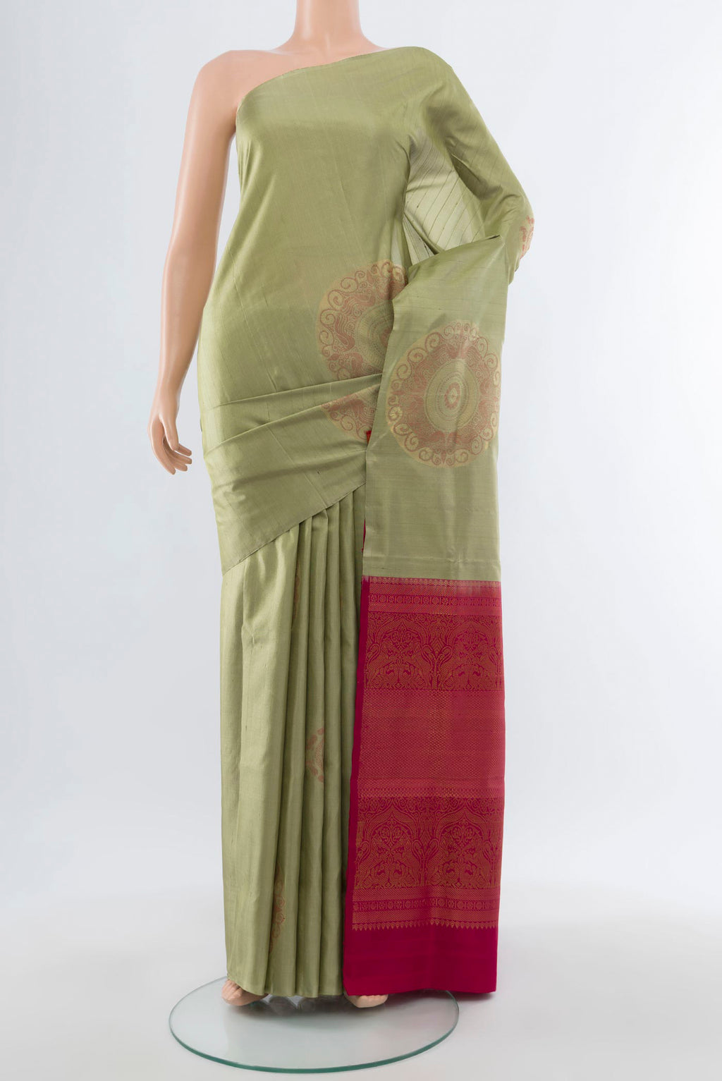 Sage Green Soft Silk Saree with Zari Butta on the body and Without Border.  displayed on a mannequin